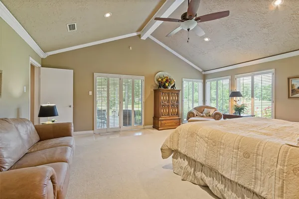 a spacious bedroom with a large bed and a large window