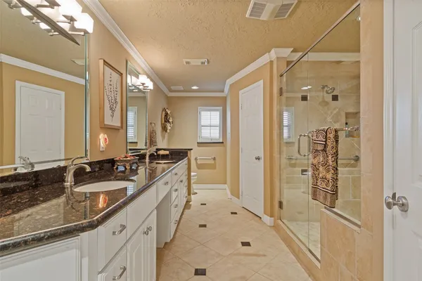 a spacious bathroom with a shower and a sink