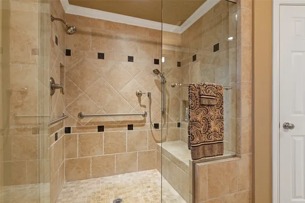 a bathroom with a shower and mirror