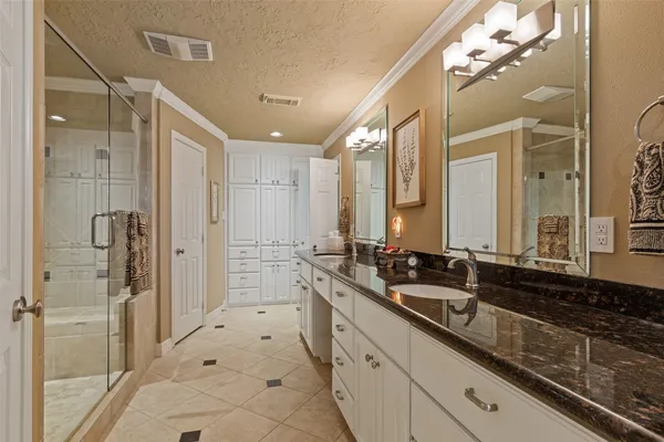 a large bathroom with a double vanity sink a mirror and a shower