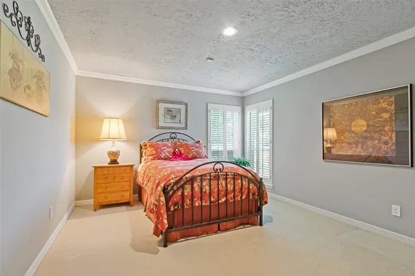 a bedroom with a bed and painting on the wall