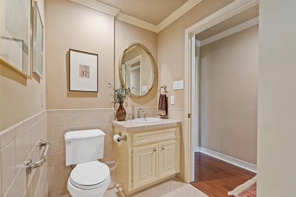 a bathroom with a toilet a sink and mirror
