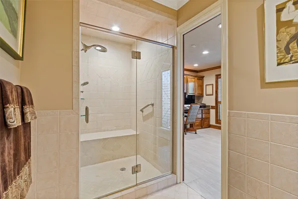 a bathroom with a glass shower door and a mirror