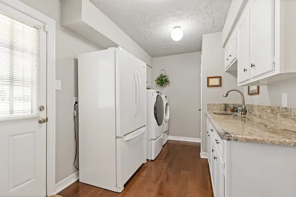 a kitchen with stainless steel appliances granite countertop a refrigerator and a sink