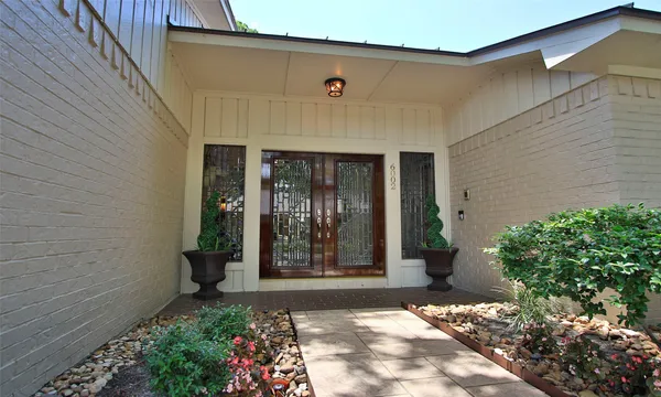 a front view of a house with garden