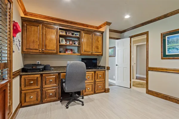 a view of a workspace with furniture and a window