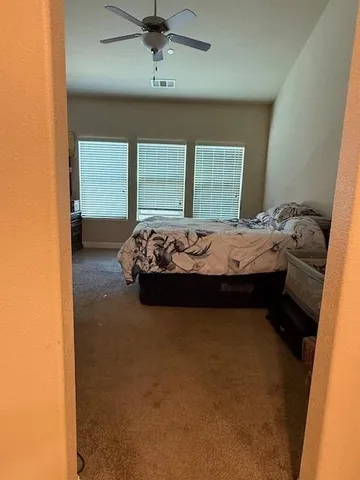 a bedroom with a bed and window