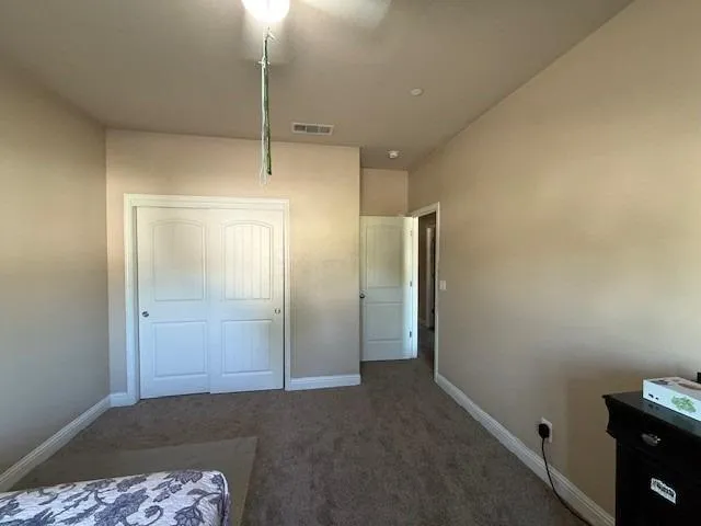 a bedroom with bed and window