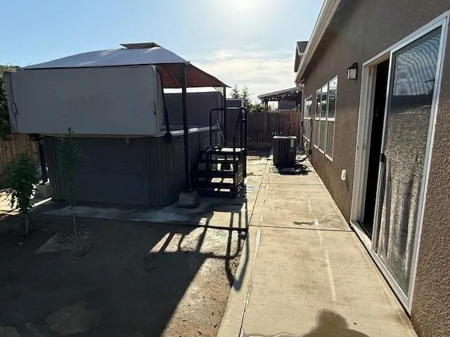 a view of a house with backyard sitting area and garden