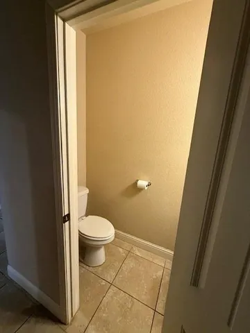 a white toilet sitting next to a shower