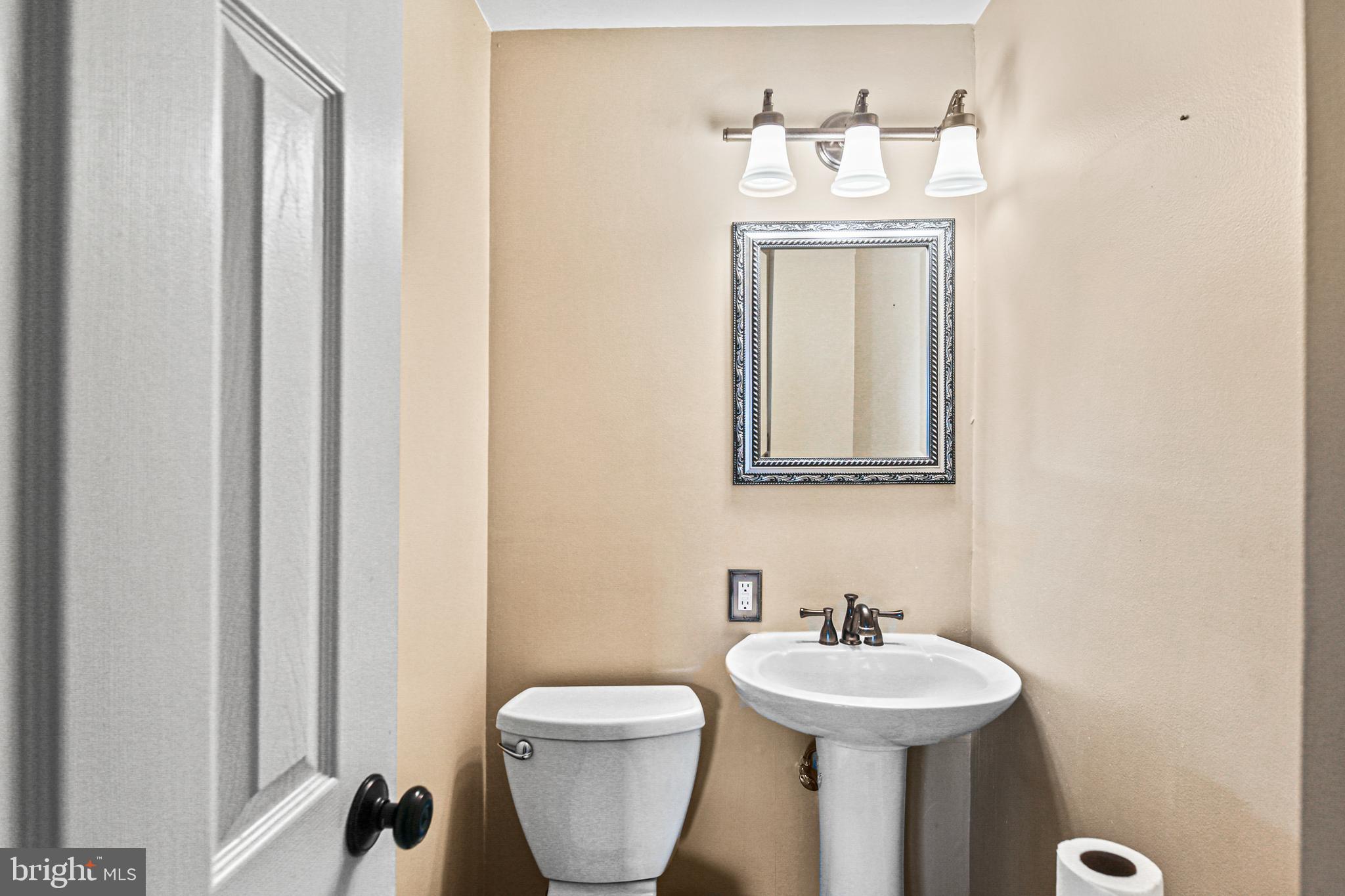 942 Grovehill Road Halethorpe, MD 21227 - Photo 12 of 30 a bathroom with a sink and a mirror