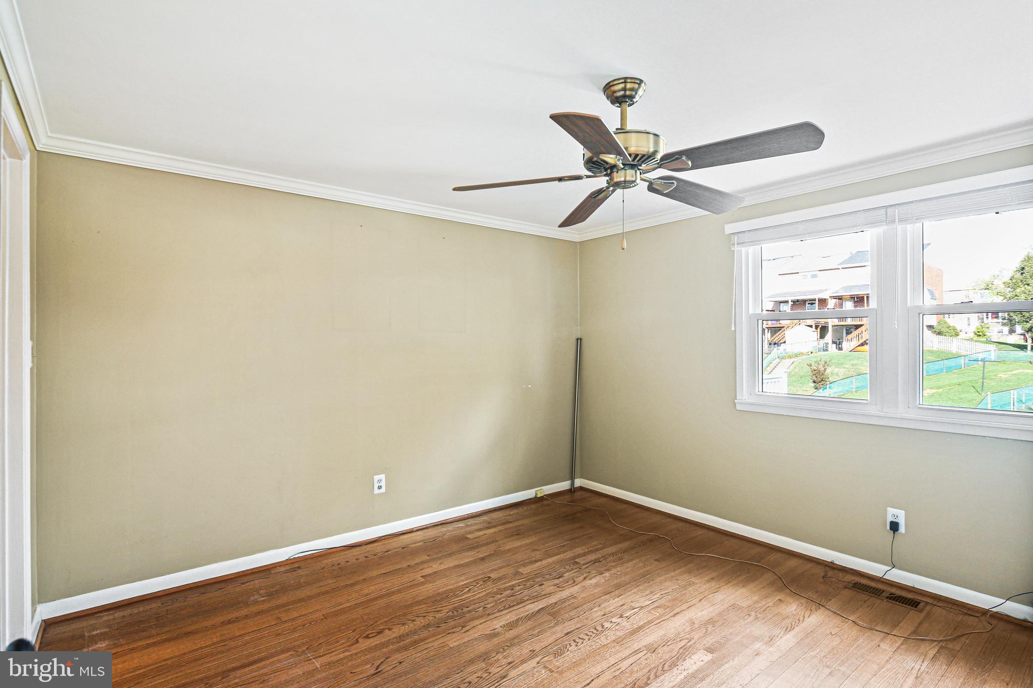 942 Grovehill Road Halethorpe, MD 21227 - Photo 14 of 30 an empty room with a window and a fan