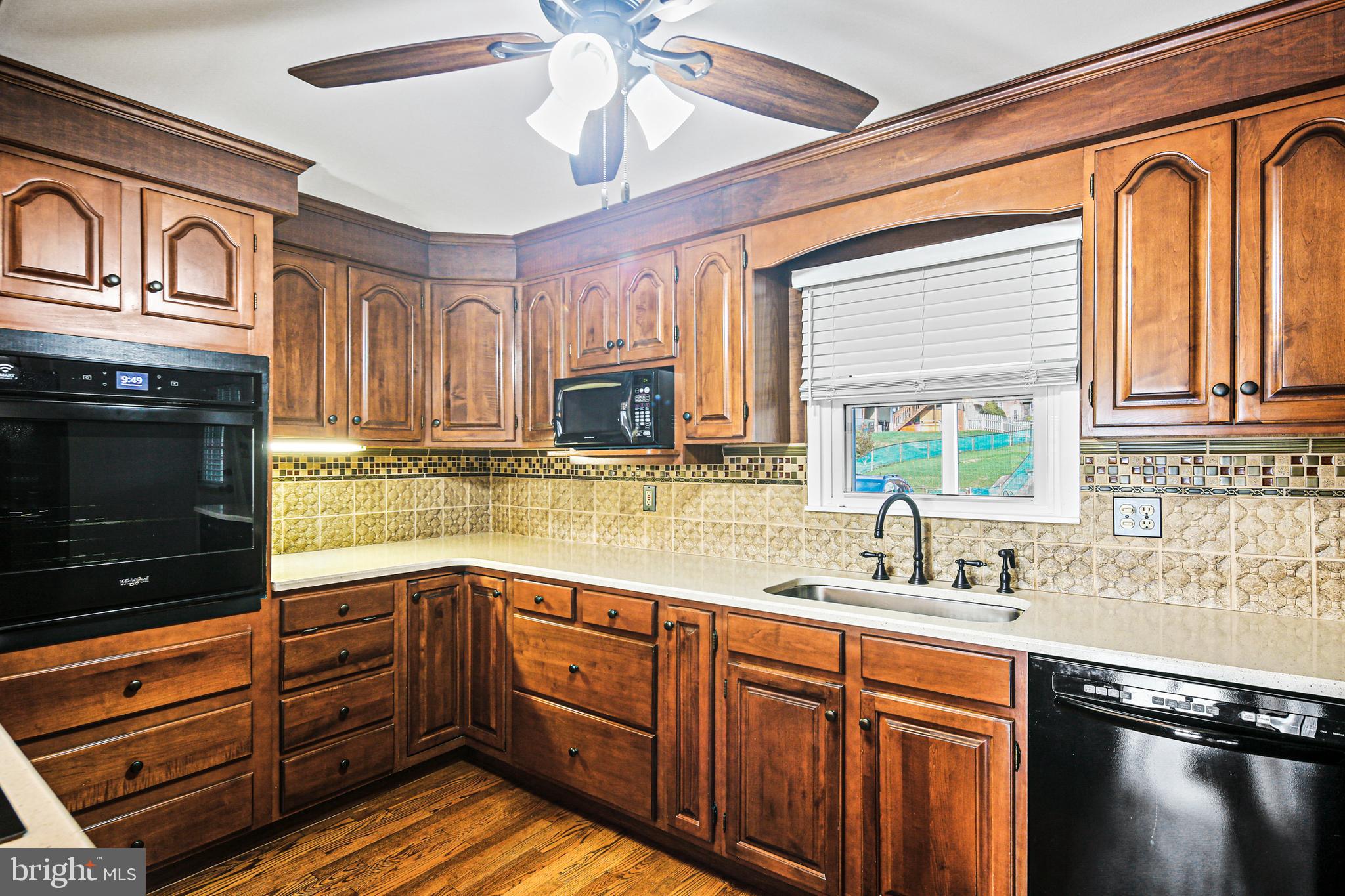 942 Grovehill Road Halethorpe, MD 21227 - Photo 17 of 30 a kitchen with stainless steel appliances granite countertop a sink and cabinets