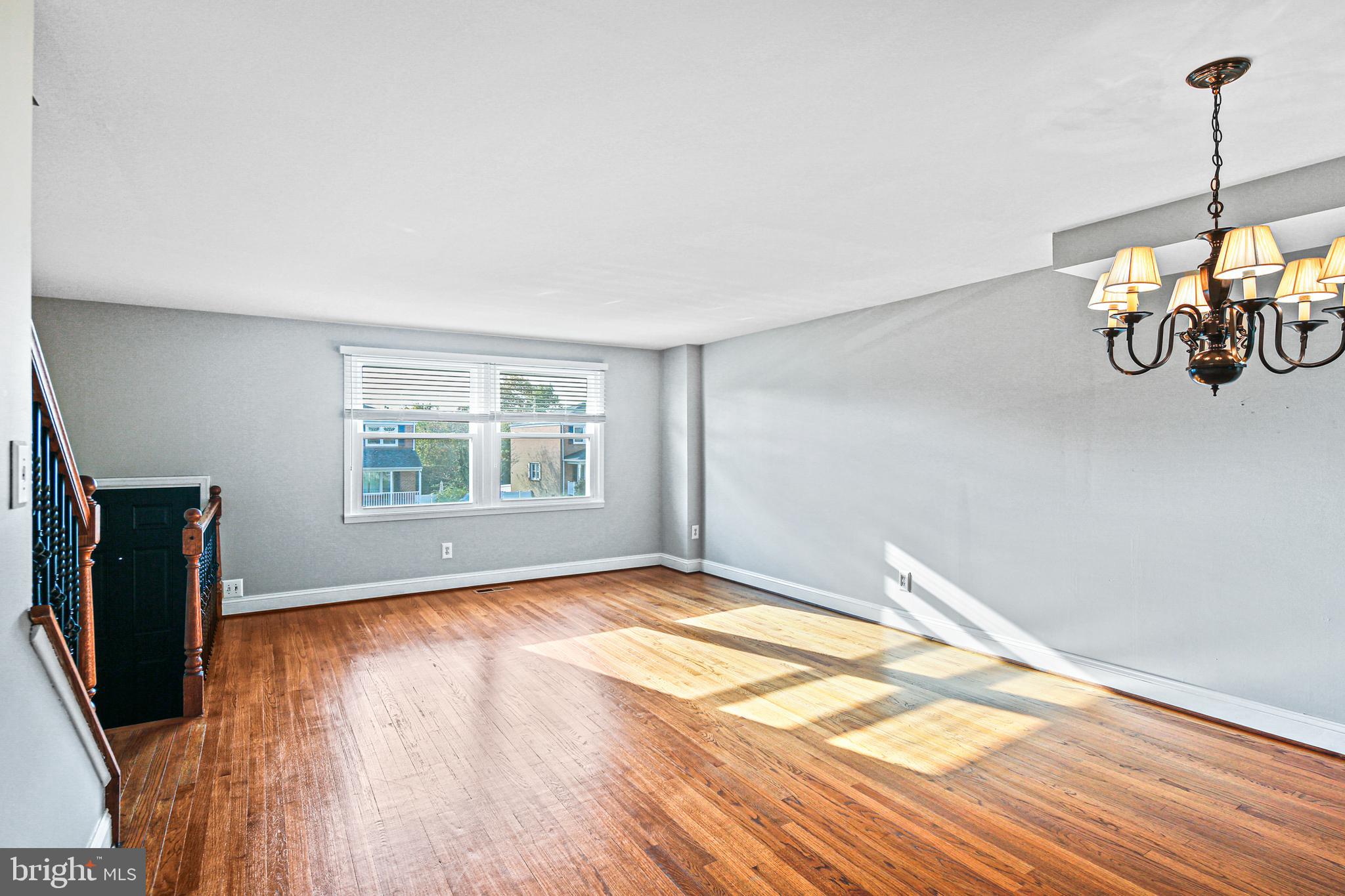 942 Grovehill Road Halethorpe, MD 21227 - Photo 18 of 30 a view of a room with blue walls and wooden floor
