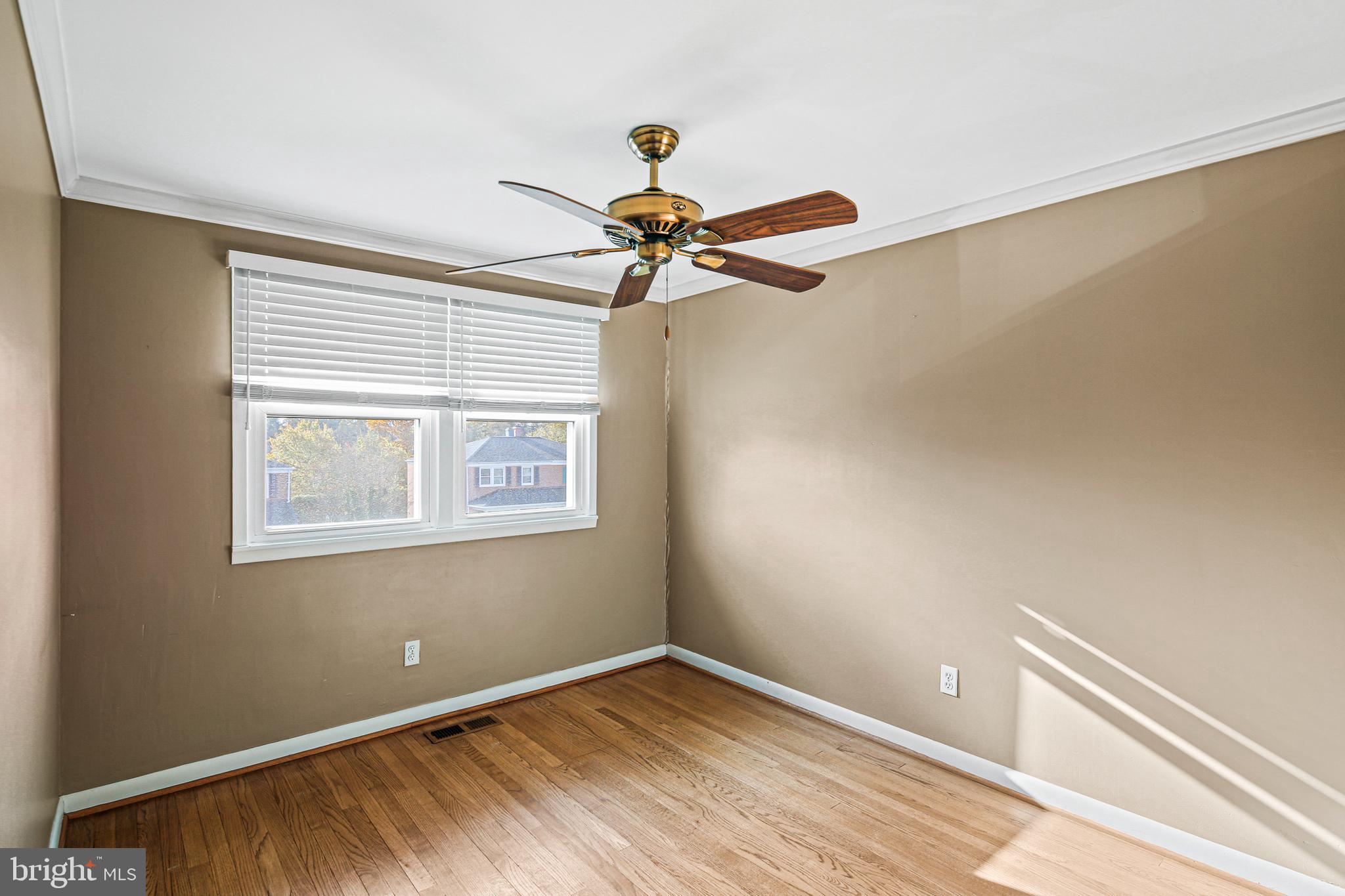 942 Grovehill Road Halethorpe, MD 21227 - Photo 21 of 30 a view of an empty room with a window and a ceiling fan