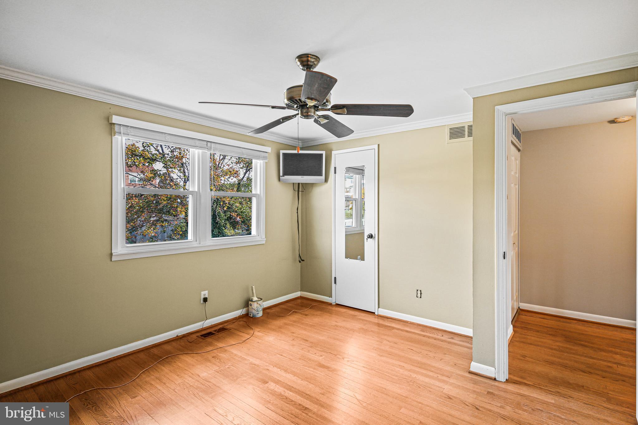 942 Grovehill Road Halethorpe, MD 21227 - Photo 23 of 30 a view of an empty room with wooden floor and a window