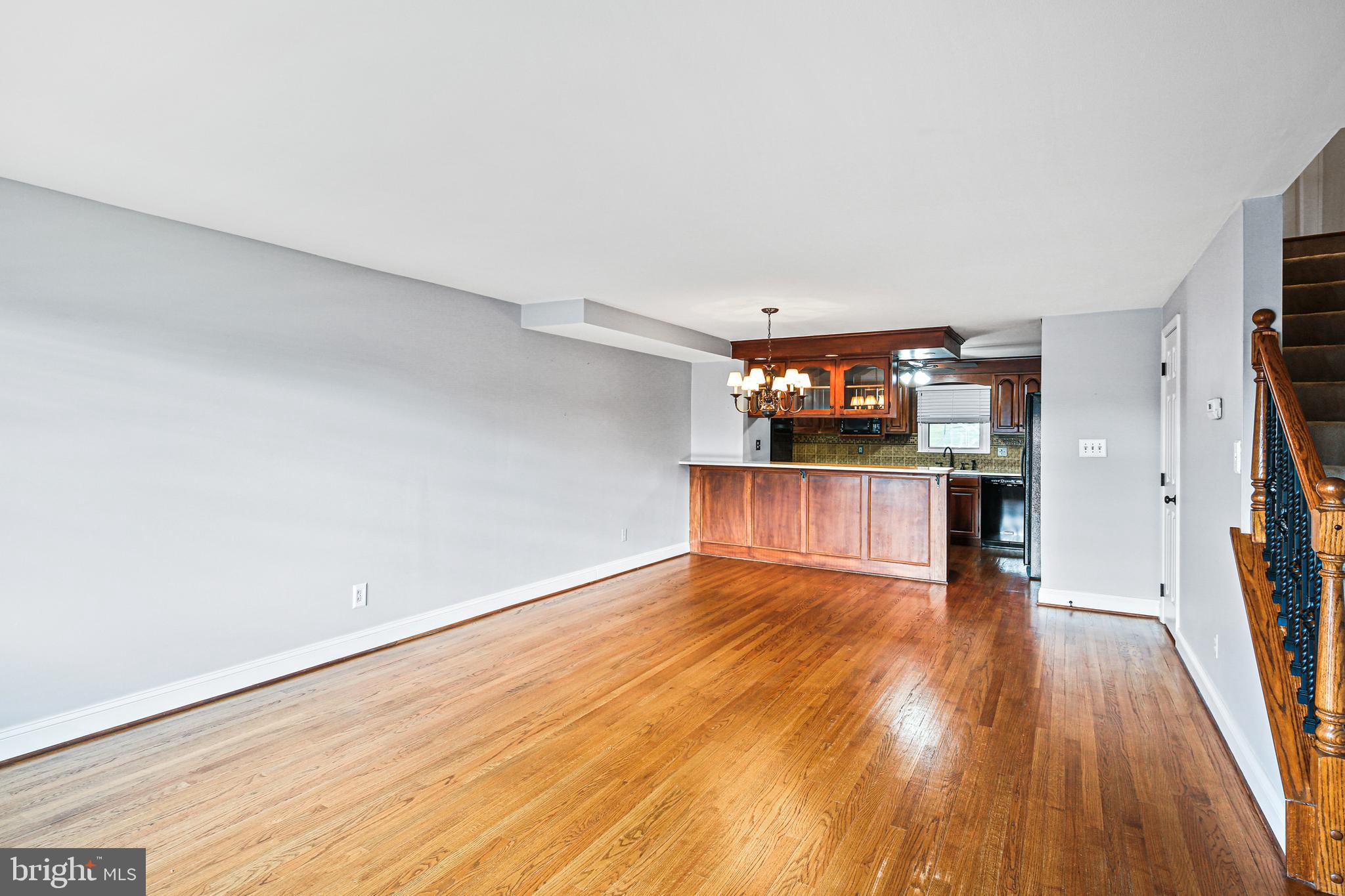 942 Grovehill Road Halethorpe, MD 21227 - Photo 7 of 30 a view of a kitchen with wooden floor and a ceiling fan