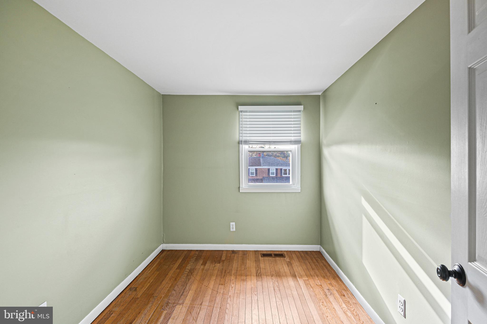 942 Grovehill Road Halethorpe, MD 21227 - Photo 9 of 30 a view of a room with wooden floor and a window