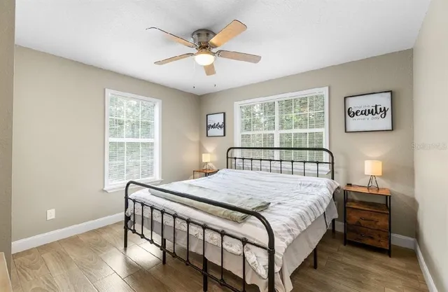 a bedroom with a bed and a large window