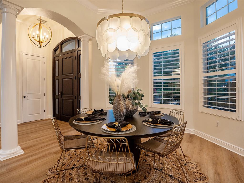 7431 Greystone Street Lakewood Ranch, FL 34202 - Photo 19 of 85 a view of a dining room with furniture and chandelier
