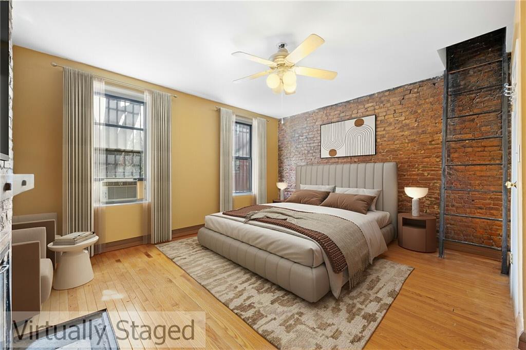 413 A 6th Avenue Brooklyn, NY 11215 - Photo 15 of 30 a bedroom with a bed and wooden floor