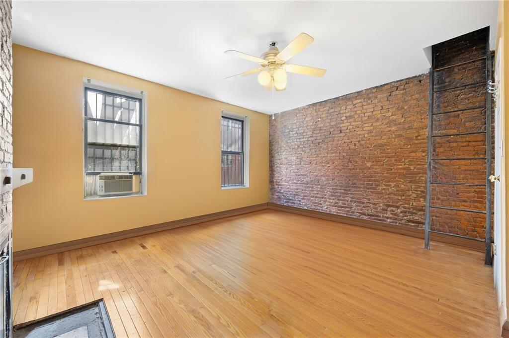 413 A 6th Avenue Brooklyn, NY 11215 - Photo 16 of 30 a view of an empty room with a window and wooden floor