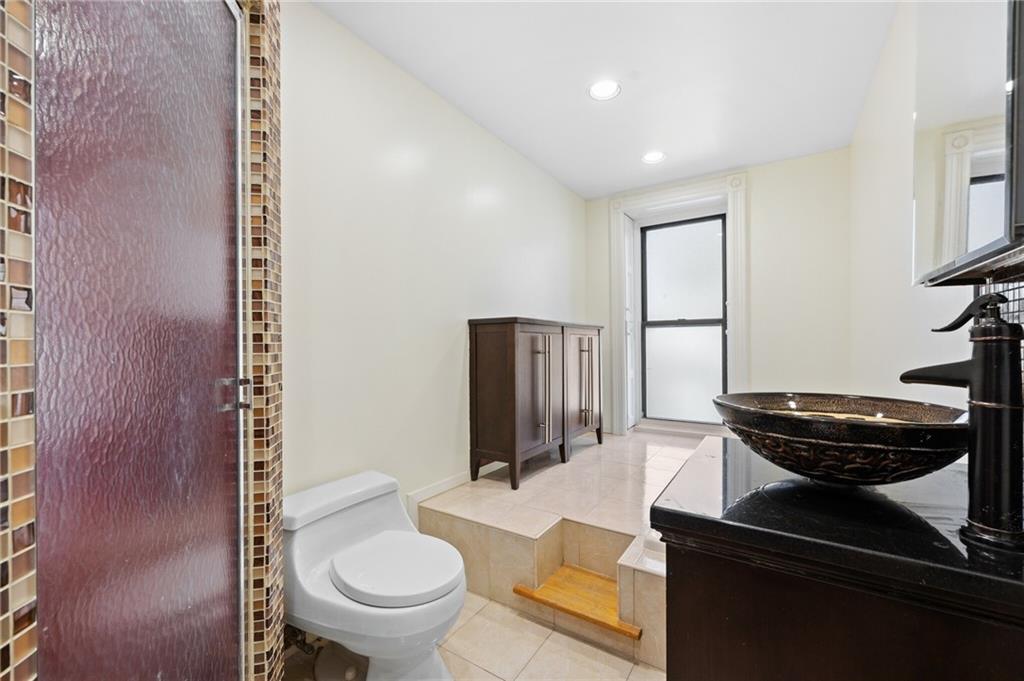 413 A 6th Avenue Brooklyn, NY 11215 - Photo 20 of 30 a bathroom with a toilet and a mirror