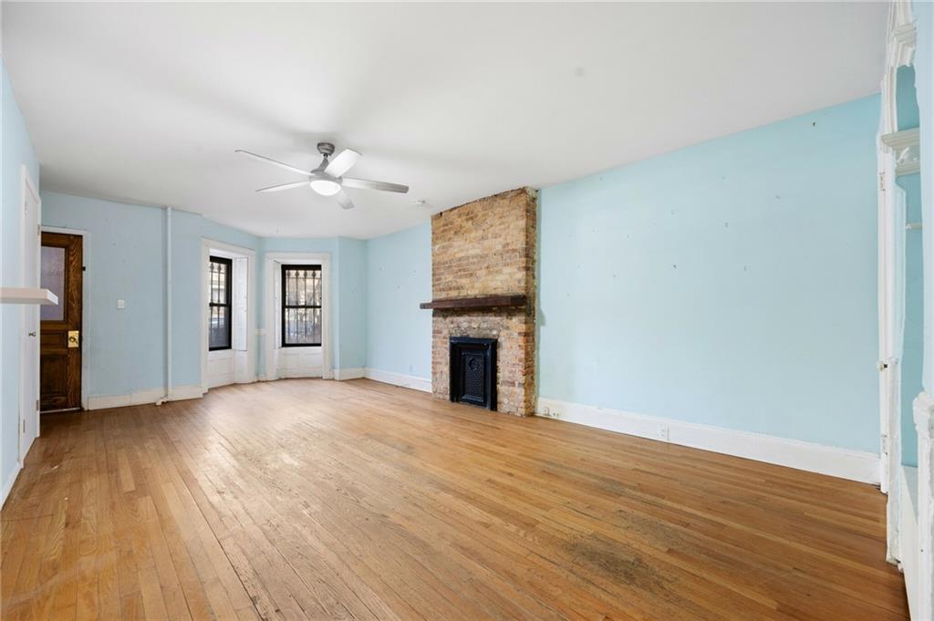 413 A 6th Avenue Brooklyn, NY 11215 - Photo 22 of 30 a view of an empty room with window and wooden floor