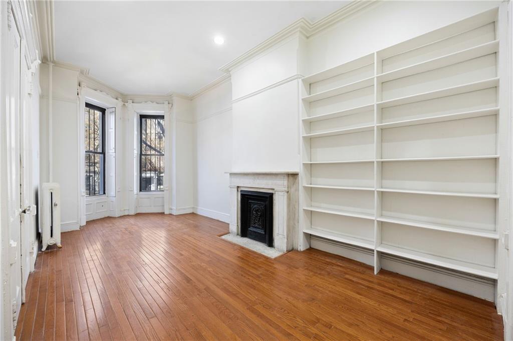 413 A 6th Avenue Brooklyn, NY 11215 - Photo 3 of 30 a view of empty room with wooden floor and fireplace