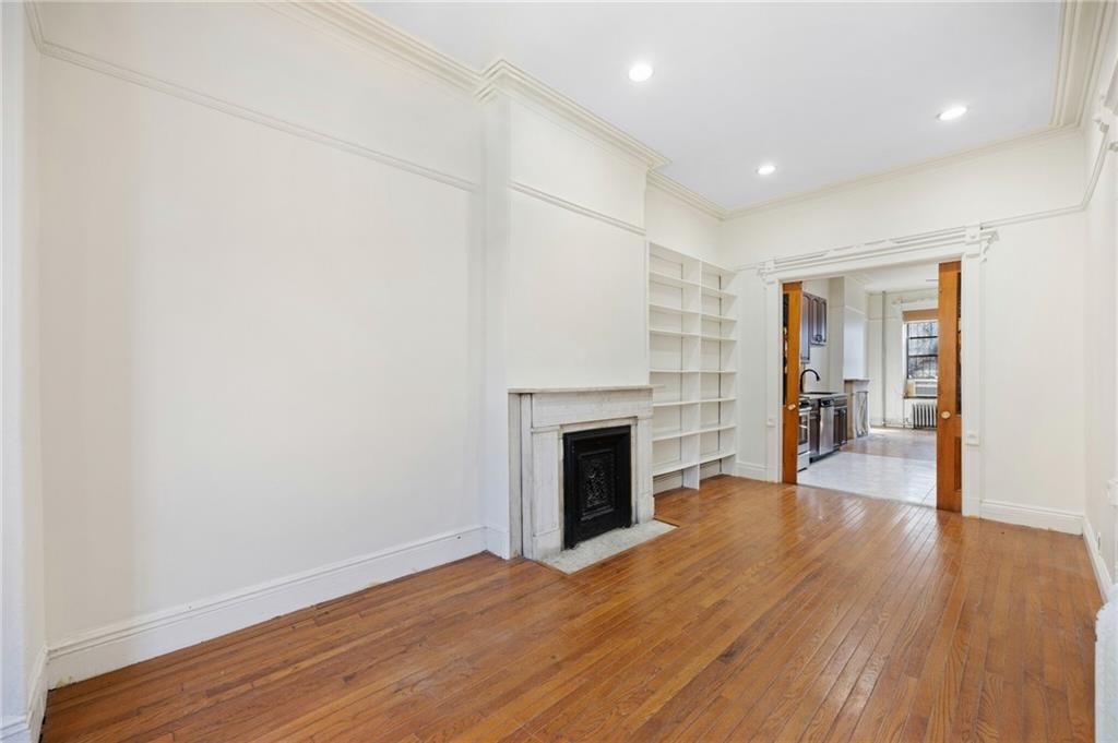 413 A 6th Avenue Brooklyn, NY 11215 - Photo 5 of 30 a view of a livingroom with wooden floor and a fireplace