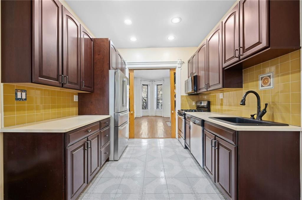 413 A 6th Avenue Brooklyn, NY 11215 - Photo 6 of 30 a kitchen with stainless steel appliances granite countertop a sink and cabinets
