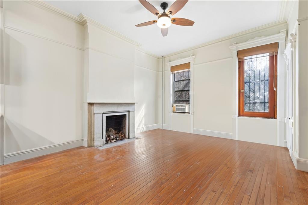 413 A 6th Avenue Brooklyn, NY 11215 - Photo 8 of 30 wooden floor fireplace and windows in an empty room