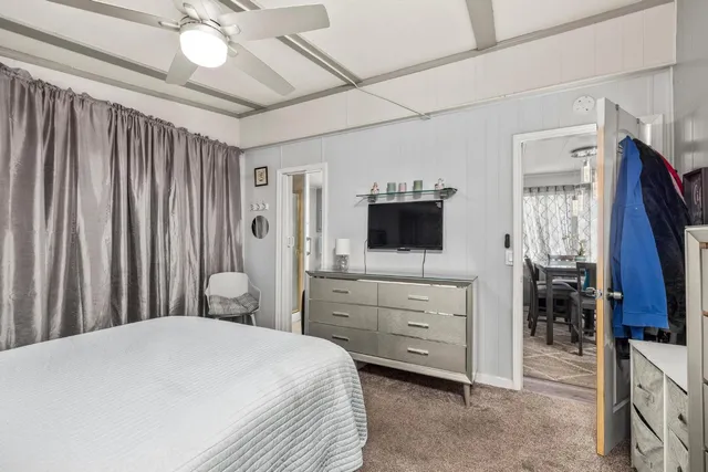 a spacious bathroom with a double vanity sink toilet mirror and bathtub