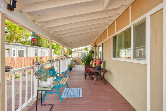 a balcony with furniture and wooden floor