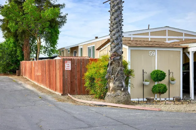 a view of a patio with table and chairs and potted plants
