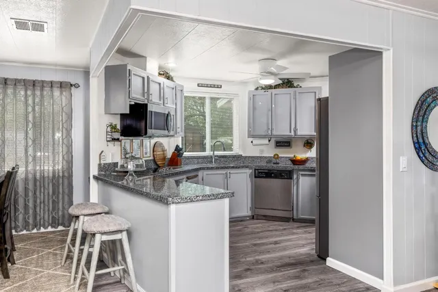 a kitchen with a stove a sink and a refrigerator