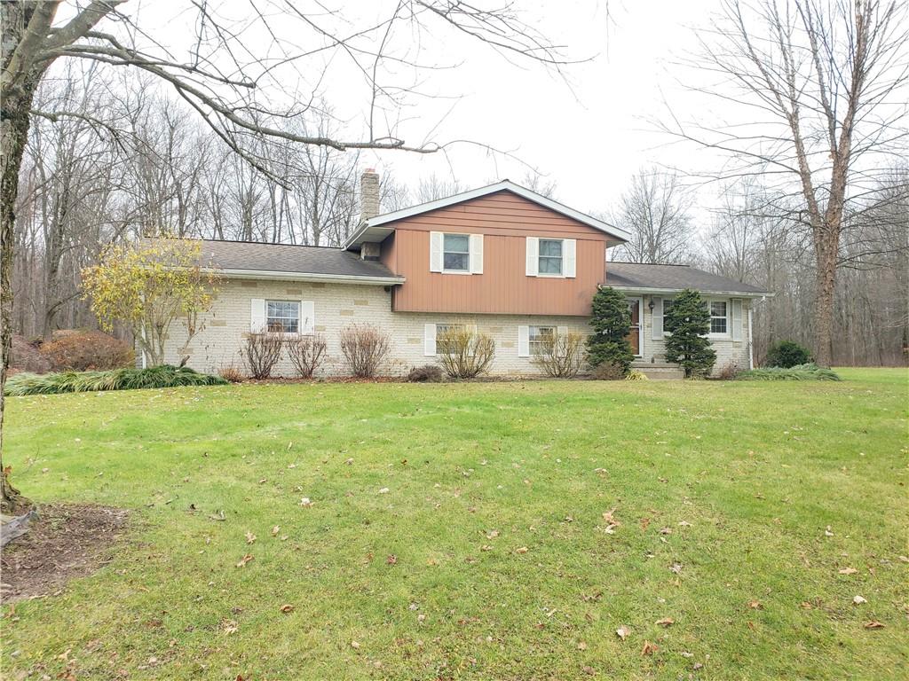 2525 Moore's Corner Road Volant, PA 16156 - Photo 1 of 40 a front view of a house with a yard and garage