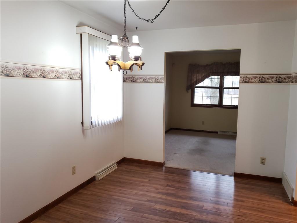 2525 Moore's Corner Road Volant, PA 16156 - Photo 11 of 40 an empty room with wooden floor and windows
