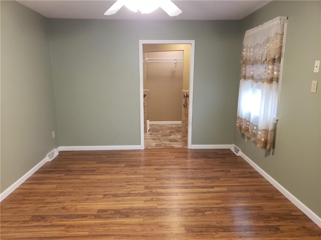 2525 Moore's Corner Road Volant, PA 16156 - Photo 13 of 40 a view of an empty room with wooden floor and a window