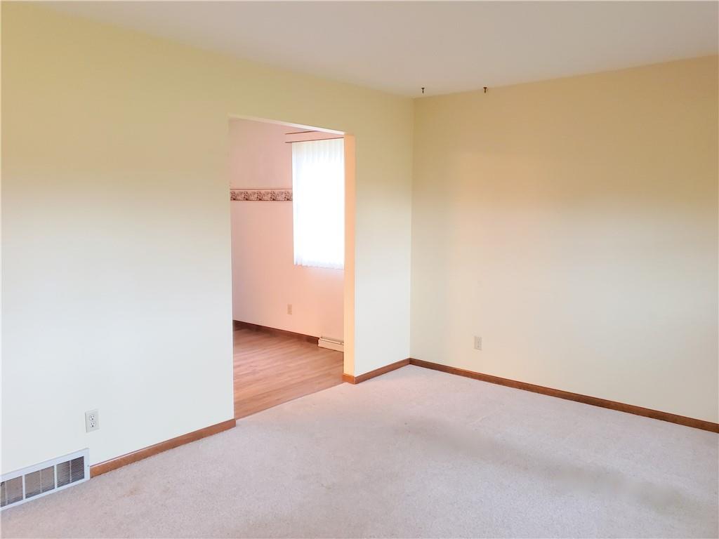 2525 Moore's Corner Road Volant, PA 16156 - Photo 4 of 40 an empty room with wooden floor and windows