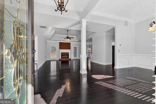 a view of entryway and hall with wooden floor