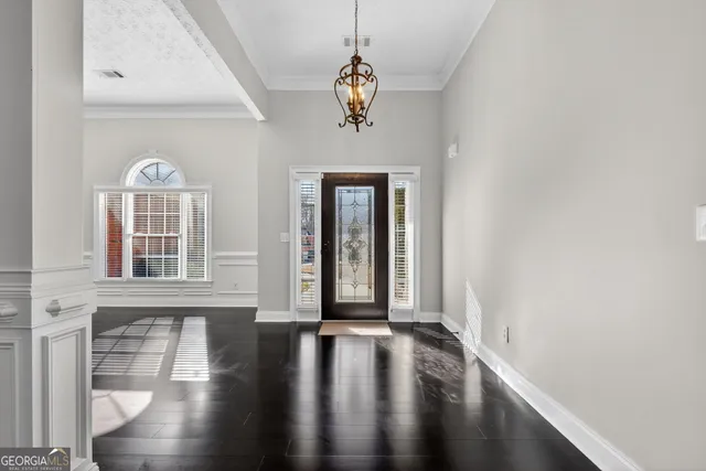 a view of a livingroom with wooden floor and a window