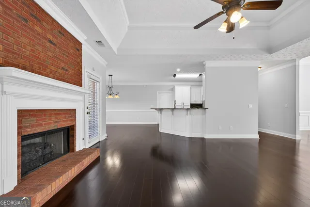 a view of empty room with wooden floor and fireplace