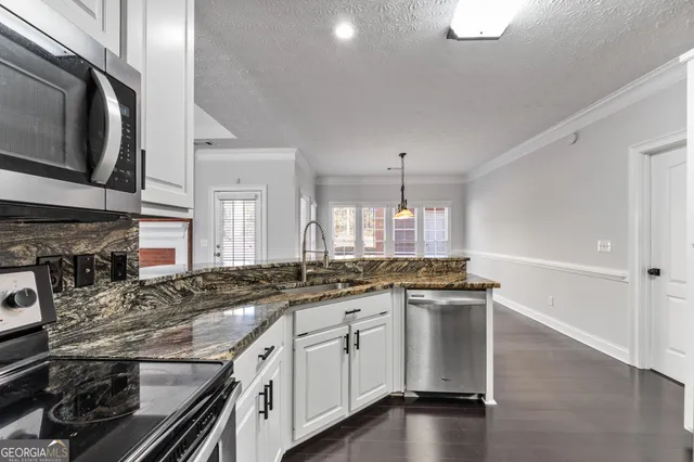 a kitchen with stainless steel appliances granite countertop a stove and a sink