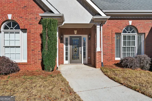 a front view of a house with garden