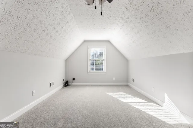 an empty room with a empty space and windows