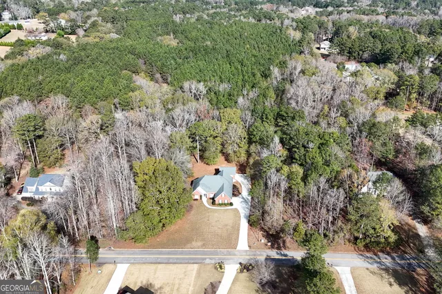 an aerial view of a residential houses with outdoor space