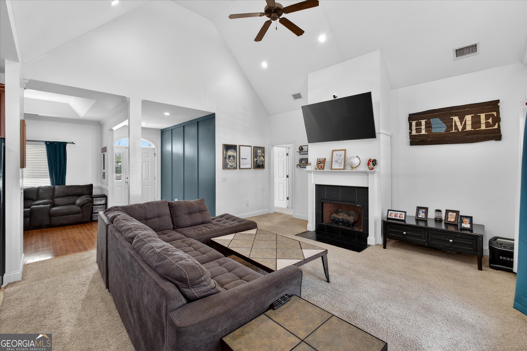 1600 Colony Lane Brooklet, GA 30415 - Photo 11 of 44 a living room with furniture a flat screen tv and a fireplace