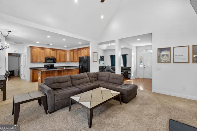 a living room with furniture and kitchen view
