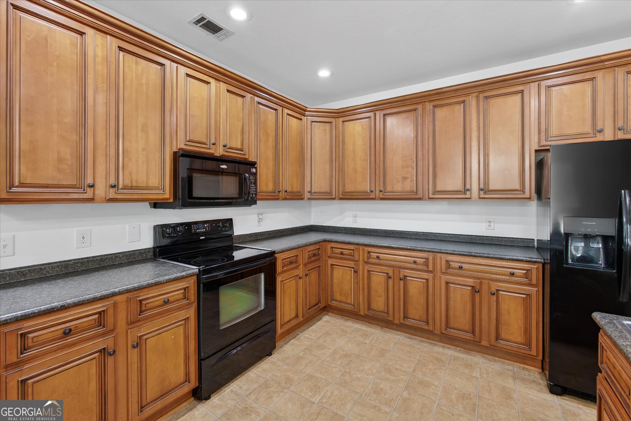 1600 Colony Lane Brooklet, GA 30415 - Photo 18 of 44 a kitchen with stainless steel appliances granite countertop a stove top oven a sink dishwasher and a microwave oven on the blue kitchen countertops